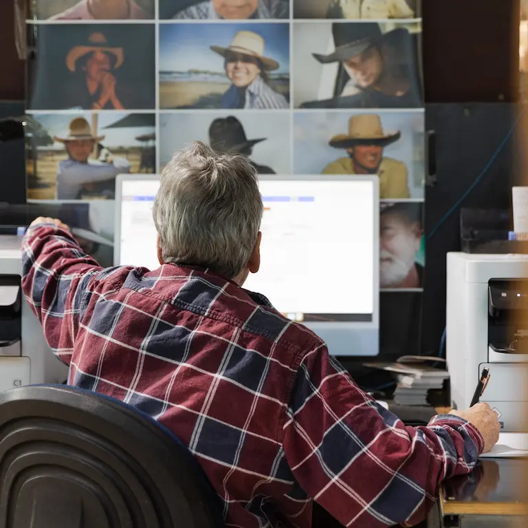 Akubra staff member working at a computer.