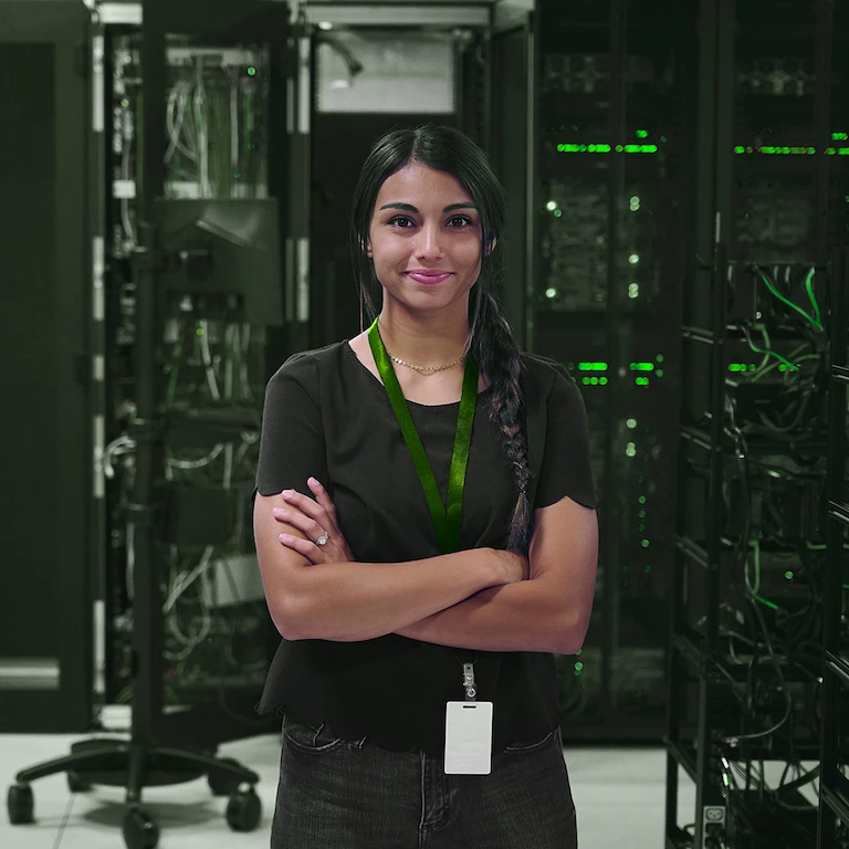 Person standing in data centre with arms folded