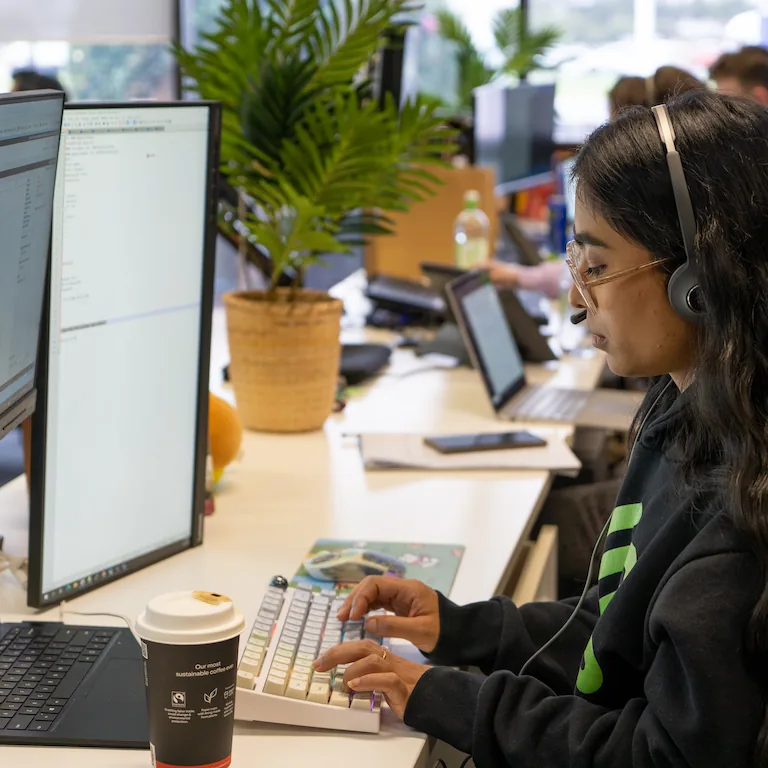 Customer service staff member working at a computer.